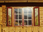 Windows of Torolmen laftehytte painted with traditional troll motives